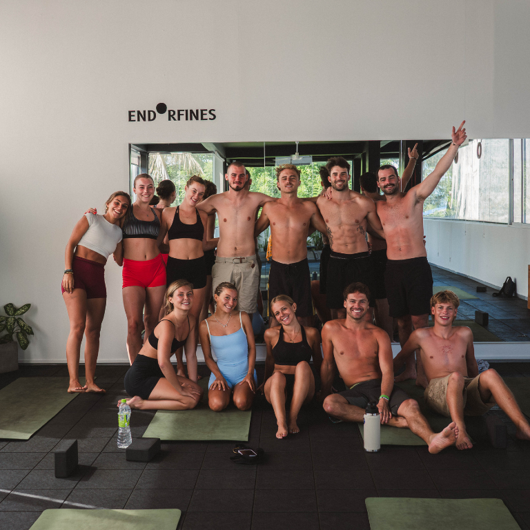 Group of solo travellers together after post-surf yoga at Elsewhere Surf Camps